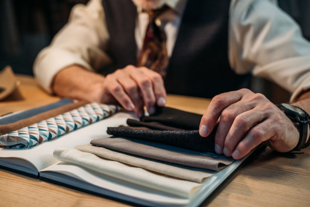 tailor comparing fabric suit quality